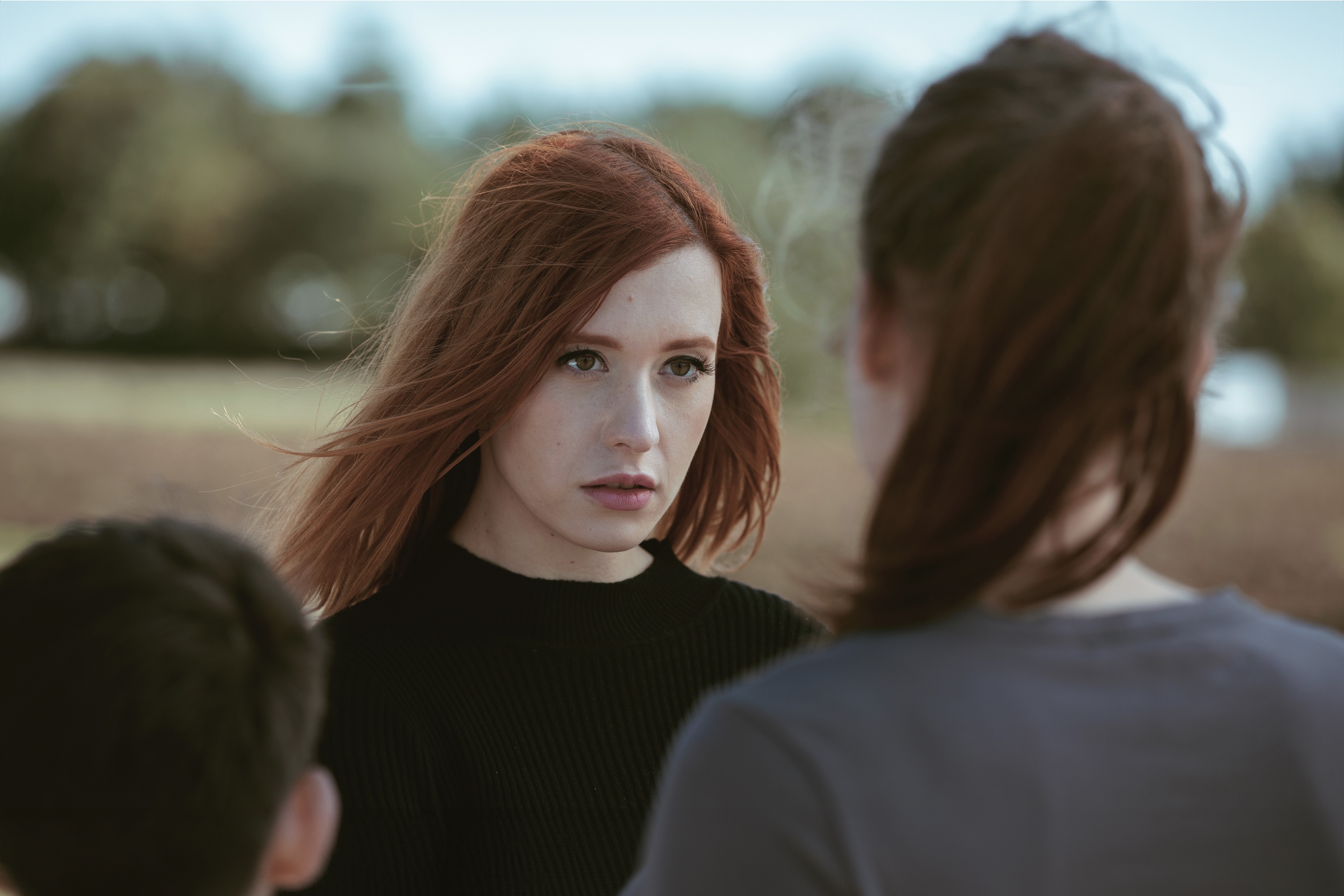 DJ facing a crowd at his deck. Photo with a purple hue